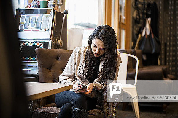 Young woman sitting at table in barbershop