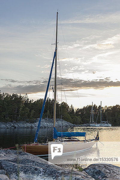 Moored boat at Stockholm archipelago during sunset
