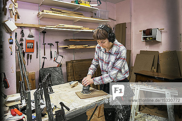 Carpenter sanding wood