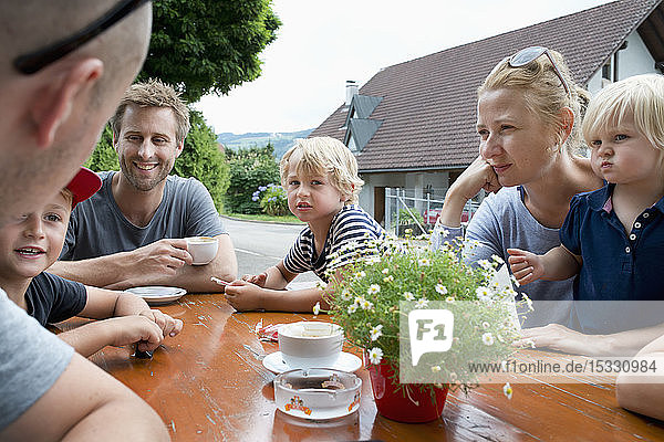 Family sitting at outdoor table