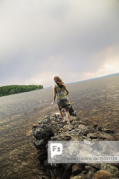 View of woman running into lake