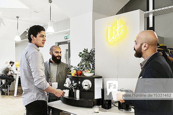 Men getting coffee in office