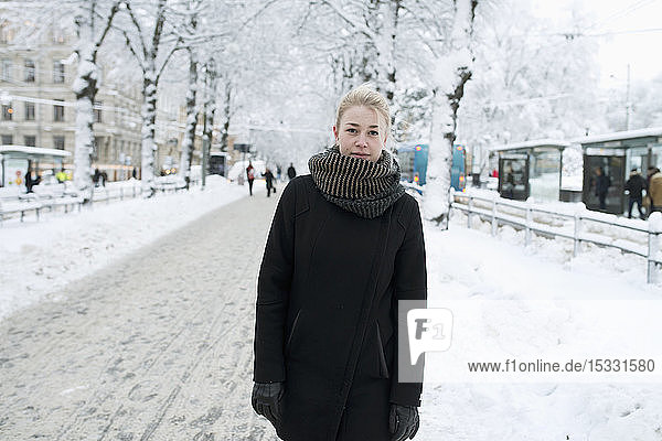Young woman standing on a snowy street