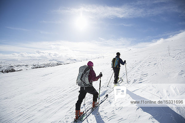 Two people cross country skiing