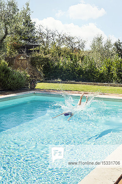 Woman diving into swimming pool