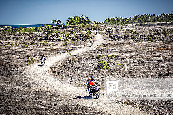 Motorcyclists on dirt road