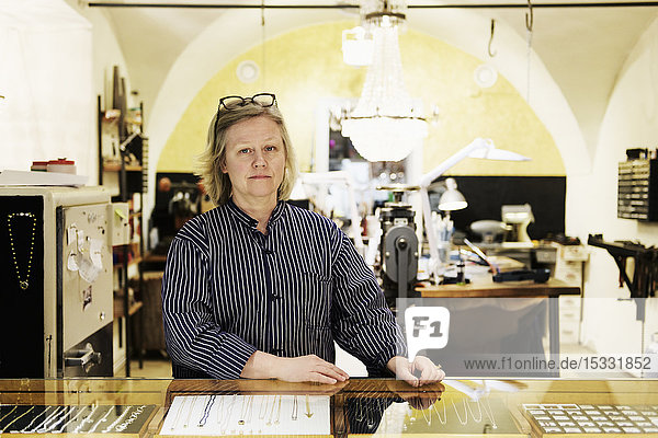 Portrait of goldsmith at counter of her jewellery store