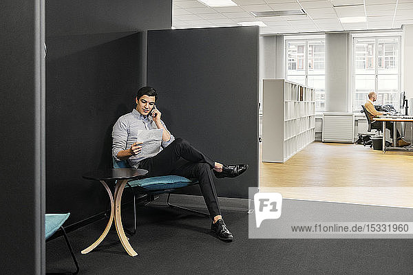 Young man on phone in office