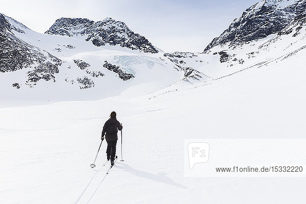 Woman skiing by on Kenekaise mountain in Lapland Sweden