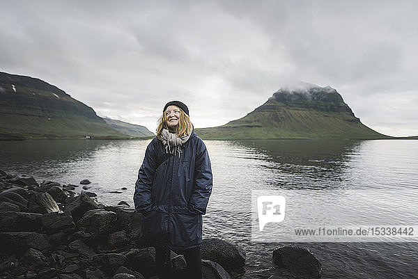 Smiling woman by Kirkjufell in Iceland