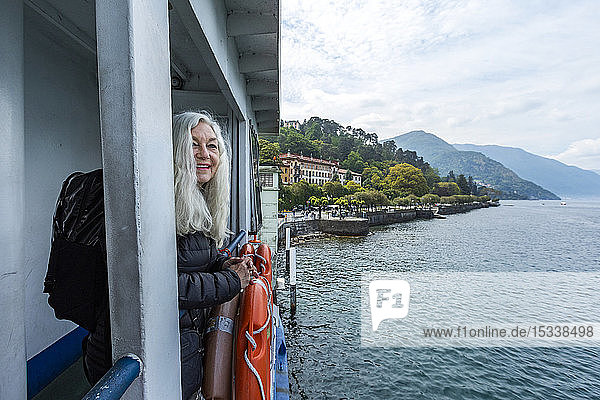 Mature woman smiling on ferry on Lake Como  Italy