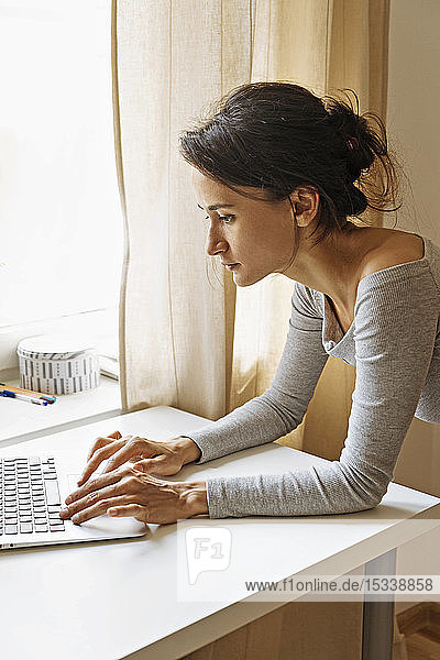 Woman using laptop on desk