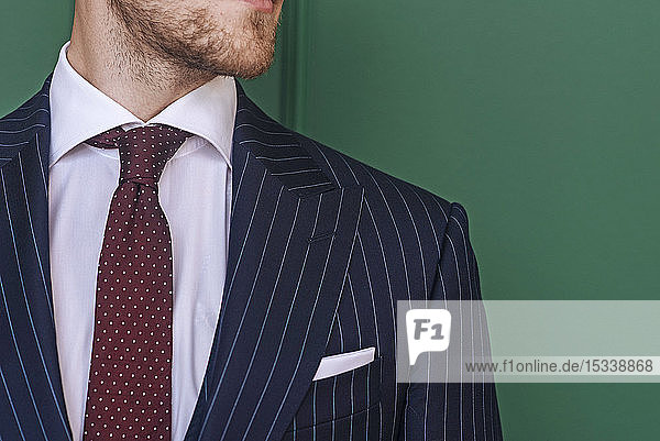Man wearing pinstripe blazer with spotted tie
