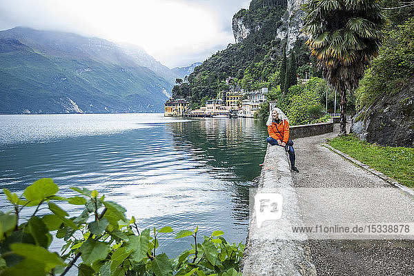 Woman on waterfront in Riva del Garda Italy