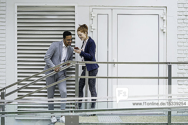 Ehepaar benutzt Smartphone im Freien
