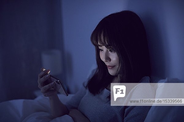 Young Japanese woman in bed