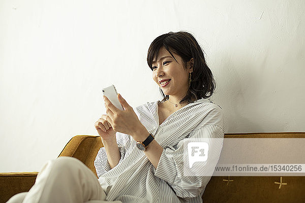 Young Japanese woman on the sofa