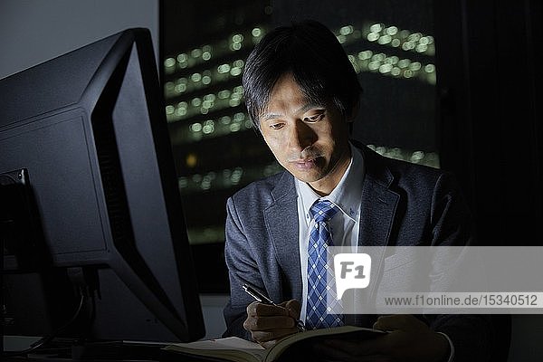 Japanese businessman working late at night