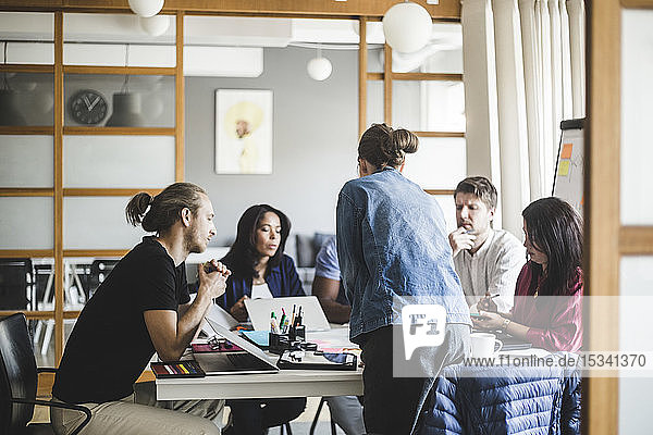Businesswoman planning strategy with colleagues in meeting at board room