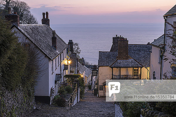 Pink dawn sky above the pretty village of Clovelly on the North Devon coast Clovelly England United Kingdom Europe