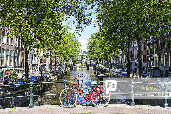 Bicycle on a bridge Leidsegracht canal Amsterdam North Holland The Netherlands Europe