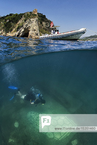 Diver swimming over a submerged Roman mosaic and ancient temple water surface above Campi Flegrei (Phlegraean Fields) Campania Italy Mediterranean Europe