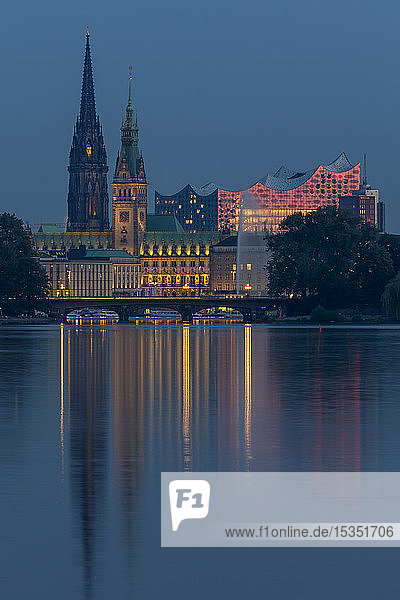 View from the Outer Alster Lake to the Elbphilharmonie  the town hall and St. Nikolai Memorial at dusk  Hamburg  Germany  Europe