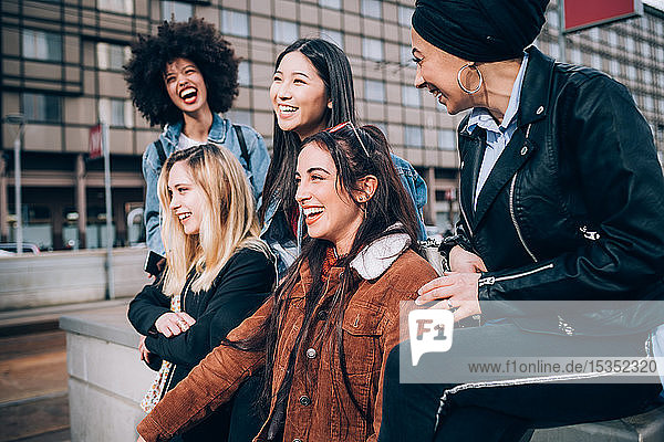 Group of friends laughing in street  Milan  Italy