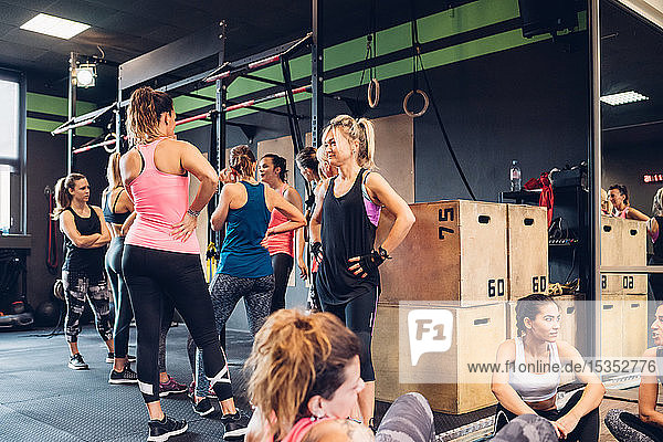 Gruppe von Frauen trainiert im Fitnessstudio  macht eine Pause und plaudert