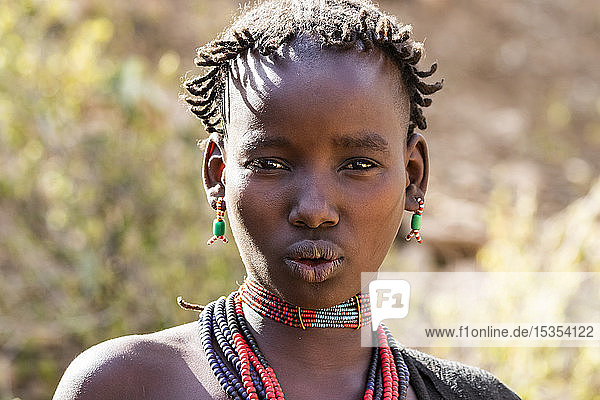 Hamer woman at a bull jumping ceremony which initiates a boy into manhood in the village of Asile; Omo Valley Ethiopia