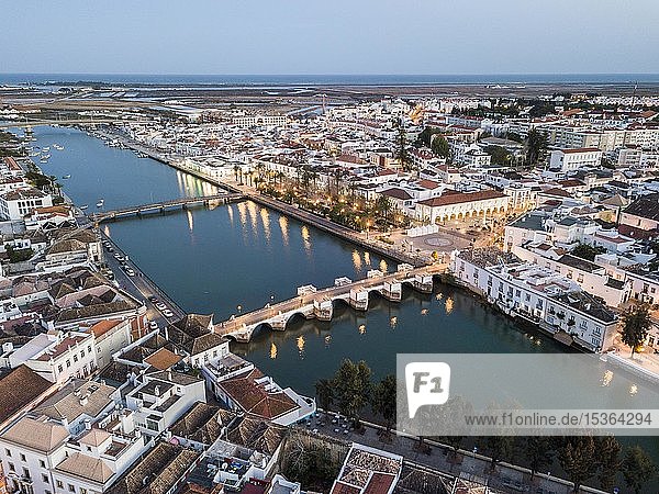 City view with roman bridge over Gilao river in old fishermen's town in the evening light  Tavira  drone shot  Algarve  Portugal  Europe