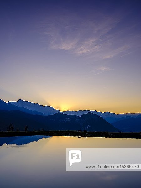 Bergsilhouetten spiegeln sich bei Sonnenuntergang in einem künstlichen Bergsee  Hochkalter  Reiteralpe  Berchtesgadener Alpen  Nationalpark Berchtesgaden  Schönau am Königssee  Berchtesgadener Land  Oberbayern  Bayern  Deutschland  Europa