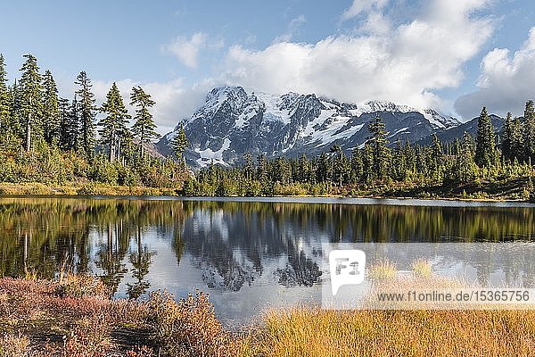 Mount Mt. Shuksan with reflection in Picture Lake  forest in front of glacier with snow  ice and rocks  Mount Baker-Snoqualmie National Forest  Washington  USA  North America