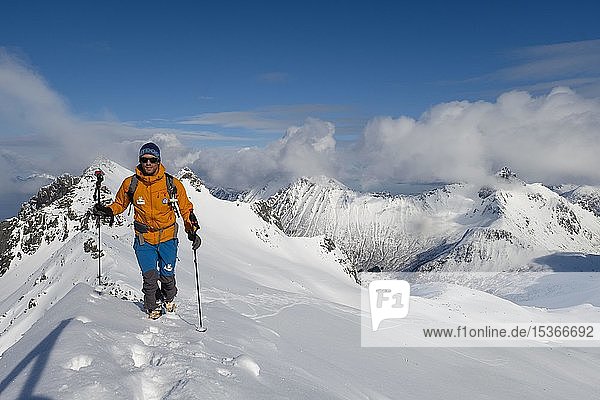 Mountaineer on the ridge to Pilan in snow  Austvågøy  Lofoten  Norway  Europe