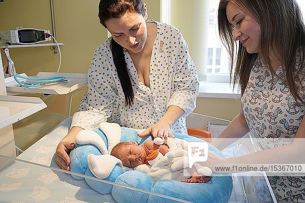 Mother with nurse takes care of newborn in intensive care unit  Karlovy Vary  Czech Republic  Europe