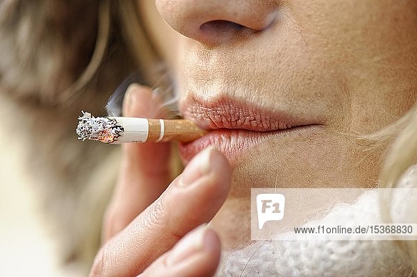Frau raucht eine Zigarette  Glühen an der Spitze der Zigarette  Nahaufnahme  Deutschland  Europa