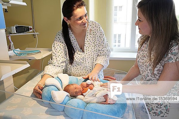 Mother with nurse takes care of newborn in intensive care unit  Karlovy Vary  Czech Republic  Europe