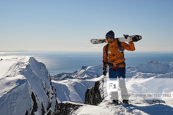 Ski mountaineer at the top of Rundfjellet  behind the Norwegian Sea  Svolvaer  Austvågøy  Lofoten  Norway  Europe