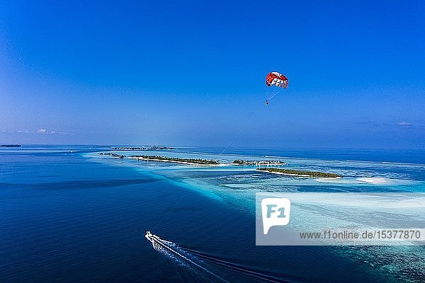 Aerial view  Paraglider flying along an atoll of the Maldives  South-Male-Atoll  Maldives  Asia