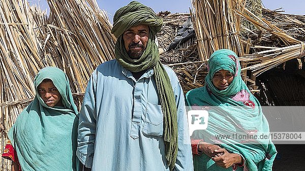Tuareg family posing in front of their hut  near Tamanrasset  Algeria  Africa