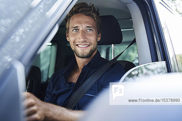 Smiling young man in car