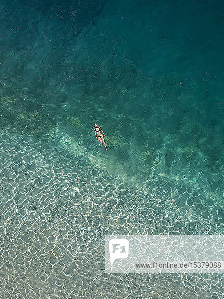 Woman floating in the sea  Gili Air  Gili Islands  Indonesia