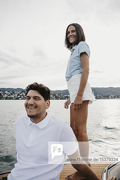 Happy young couple on a boat trip on a lake