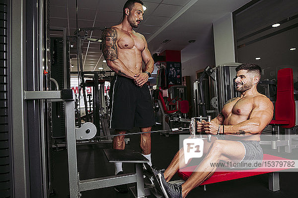 Muscular men training in gym