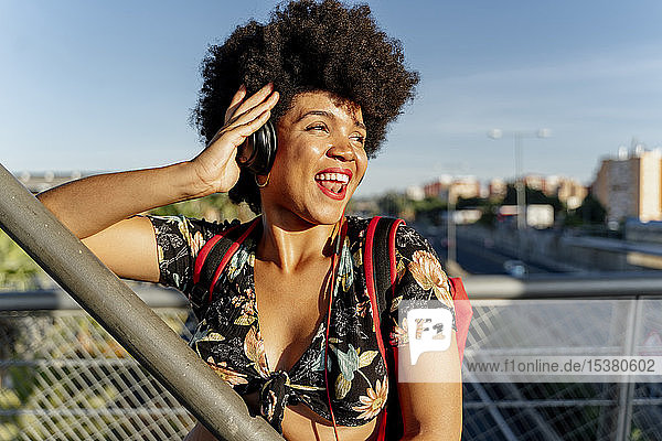 Weibliche Afroamerikanerin mit Kopfhörern  die Musik hört und zur Seite schaut