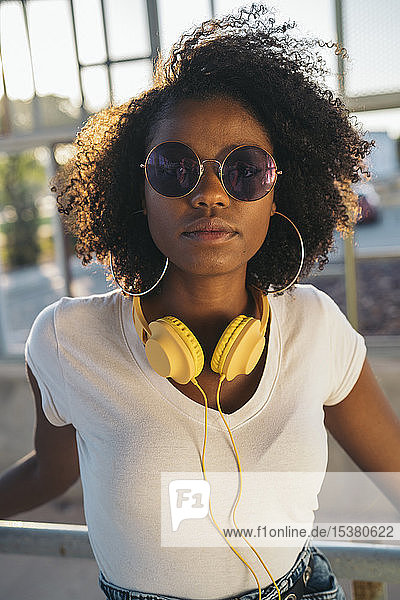 Portrait of young woman with sunglasses and headphones