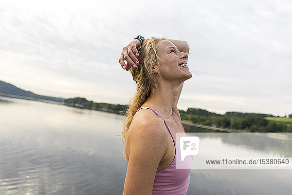 Happy young woman at a lake