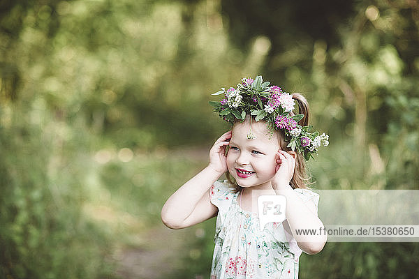 Portrait of smiling little girl with flower wreath