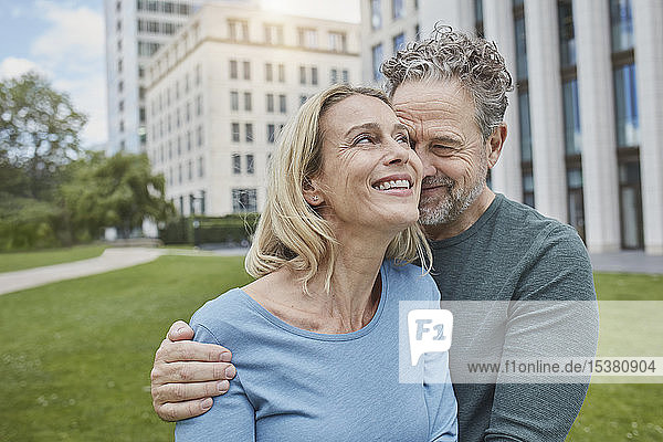 Happy mature couple hugging in the city