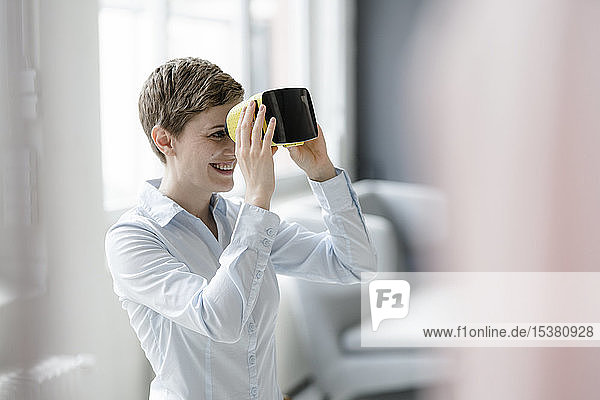 Smiling woman with VR glasses in office